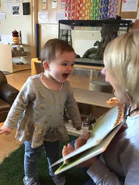educator reading to an infant